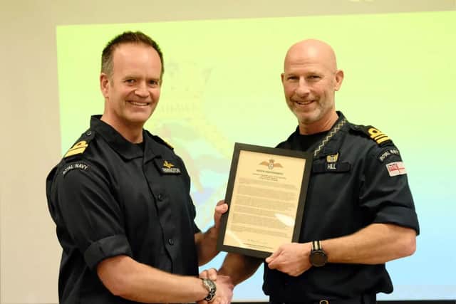 RAdm Rimington presents a Green Endorsement to Lt Cdr Adrian Hill