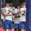 John Swift, left, celebrates scoring in Pompey's 3-1 win at Millwall