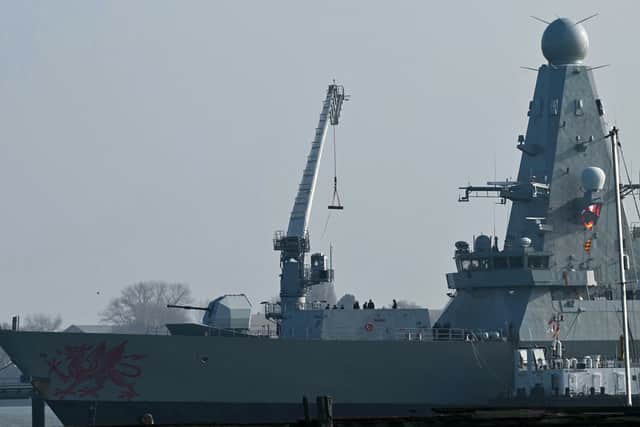 Goods are loaded onto HMS Dragon, a Royal Navy Type 45 Daring-class air-defence destroyer warship, moored at the HMNB Portsmouth Upper Harbour Ammunition Facility (UHFC), outside HM Naval Base Portsmouth.