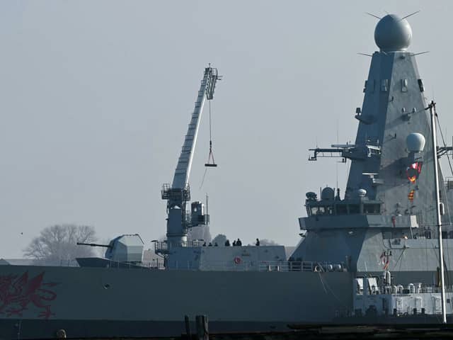 Goods are loaded onto HMS Dragon, a Royal Navy Type 45 Daring-class air-defence destroyer warship, moored at the HMNB Portsmouth Upper Harbour Ammunition Facility (UHFC), outside HM Naval Base Portsmouth.