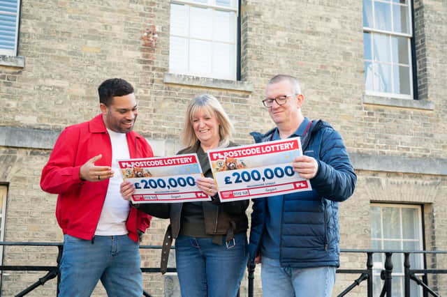 Sharon Healy and Chris Smith of Gosport with, left, Danyl Johnson from the People's Postcode Lottery