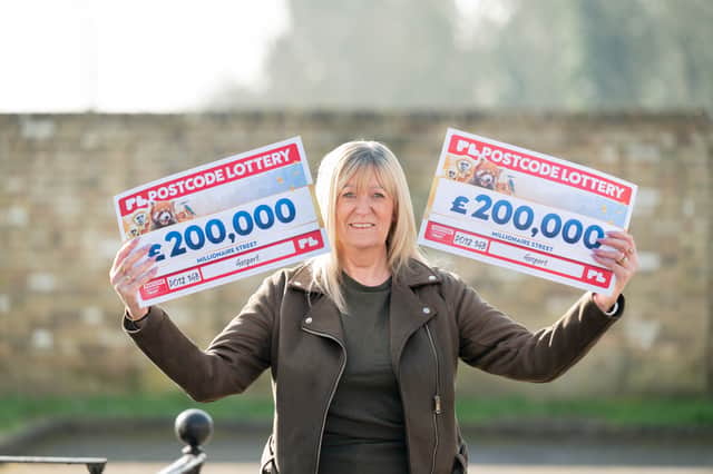 Sharon Healy from Gosport with her £400,000 winning cheques from the People's Postcode Lottery