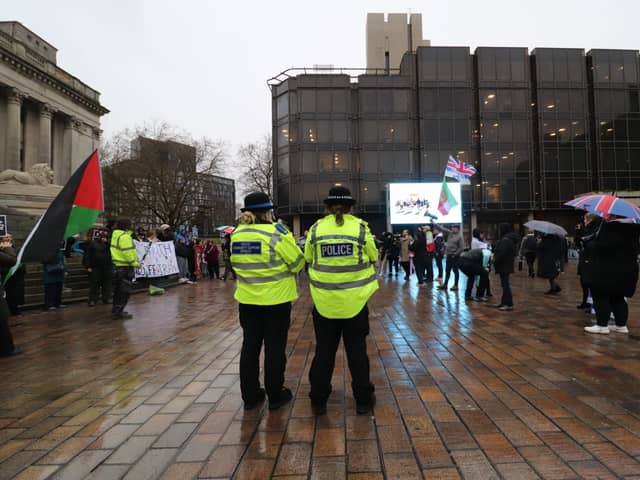 Police monitor the two sides apart at the Iran war protests in Guildhall Square in Portsmouth on Friday, March 6.