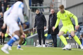 Pompey boss John Mousinho watches the game unfold at Ewood Park