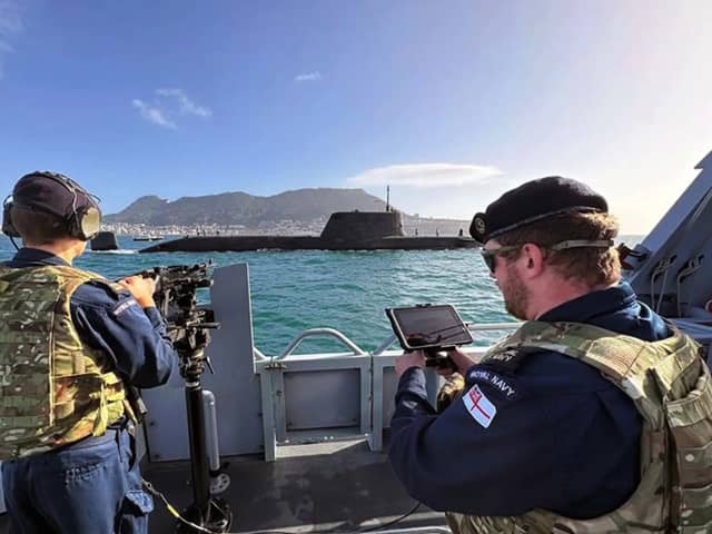 New surveillance drone are being used by the Royal Navy in Gibraltar. Pictured: HMS Dagger uses a drone to watch over HMS Anson as the submarine departs Gibraltar.