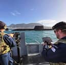 New surveillance drone are being used by the Royal Navy in Gibraltar. Pictured: HMS Dagger uses a drone to watch over HMS Anson as the submarine departs Gibraltar.