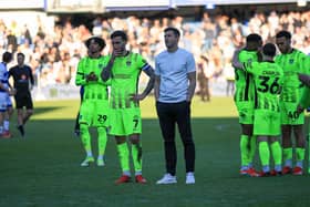 Pompey boss John Mousinho looks towards the Pompey fans who travelled to west London for Saturday's 6-1 defeat at QPR.
