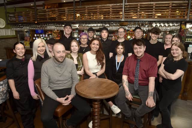 Pub manager Lucy Dempsey, centre, surrounded by staff at The Round Coppice.