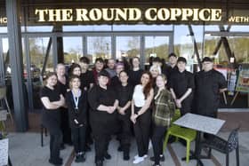 Lucy Dempsey (front, second from right), pub manager, with her team at The Round Coppice. 