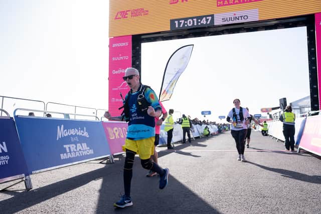 Clarke Reynolds passes the finish line of the Brighton Marathon.