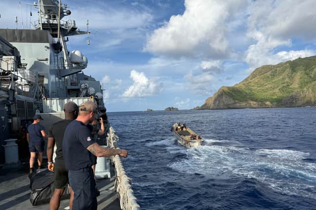 HMS Tamar sailors off the coast of Pitcairn Island.