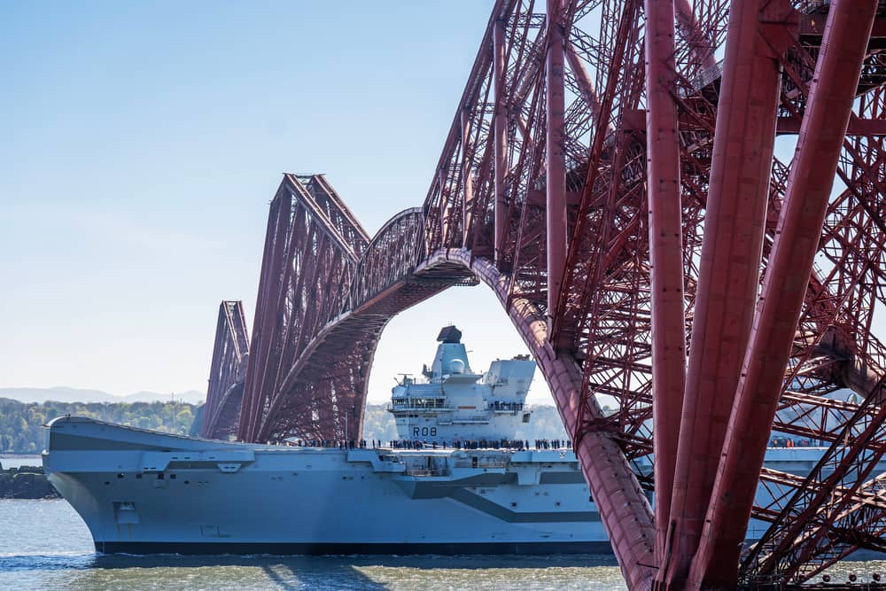 HMS Queen Elizabeth passes under the Forth Bridge heading out to sea after leaving Rosyth, Fife, following an extended maintenance period. 
Picture: Jane Barlow/PA Wire