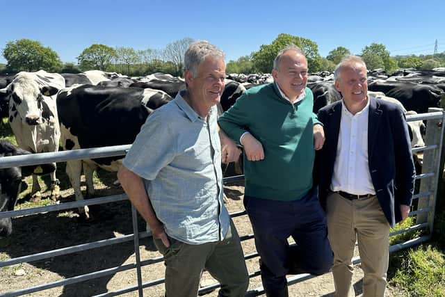 Liberal Democrat leader Sir Ed Davey (centre) with dairy farmer Peter Caines (left) and Liberal Democrat Parliamentary Candidate for East Hampshire, Dominic Martin, during a visit to Stanbridge dairy farm near Petersfield