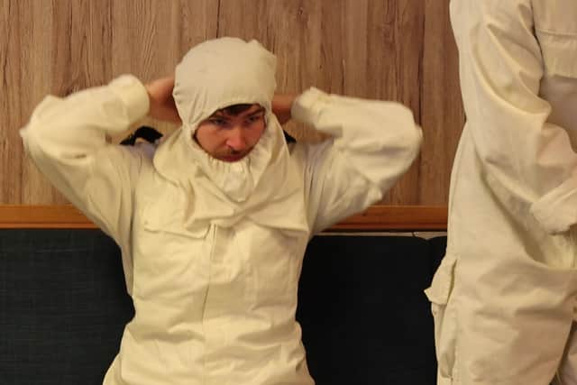 Sailors on HMS Dragon putting on protective gear as they rehearse drills for attacks by ballistic missiles