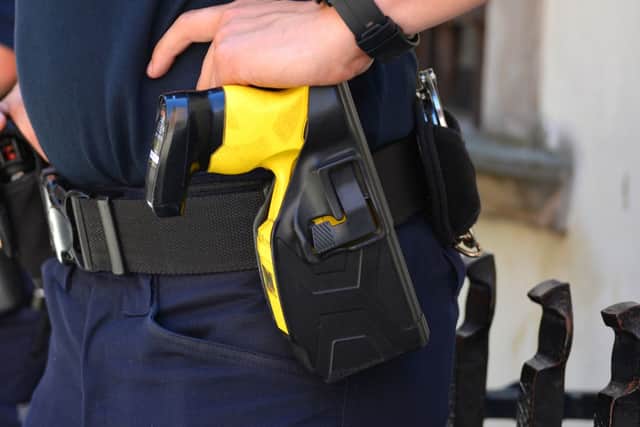 The defendant tried to grab a police officer's taser after throwing out racial slurs at him, the court heard.