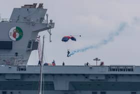 Royal Navy Parachute Display Team landing on the flight deck of Royal Navy aircraft carrier HMS Queen Elizabeth.