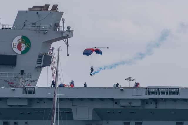 Royal Navy Parachute Display Team landing on the flight deck of Royal Navy aircraft carrier HMS Queen Elizabeth.