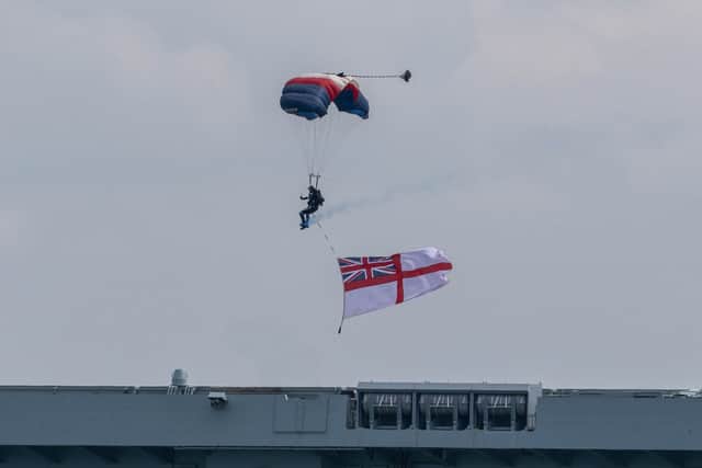 Royal Navy Parachute Display Team landing on the flight deck of Royal Navy aircraft carrier HMS Queen Elizabeth.
