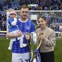 Jack Sparkes with the League One trophy he won at Pompey. Pictured with Lily (left) and his partner Abbie. Picture: Jason Brown/ProSportsImages