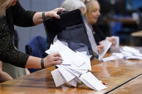 Ballot papers are removed from a ballot box at Fareham Leisure Centre during counting for the 2024 general election