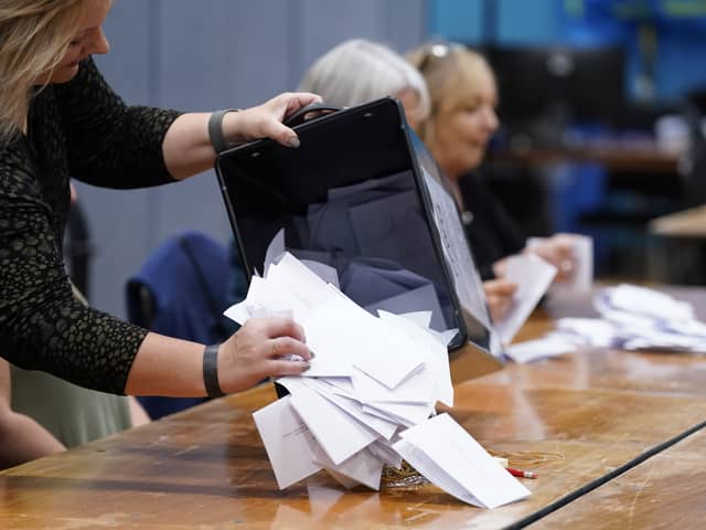 Ballot papers are removed from a ballot box at Fareham Leisure Centre during counting for the 2024 general election