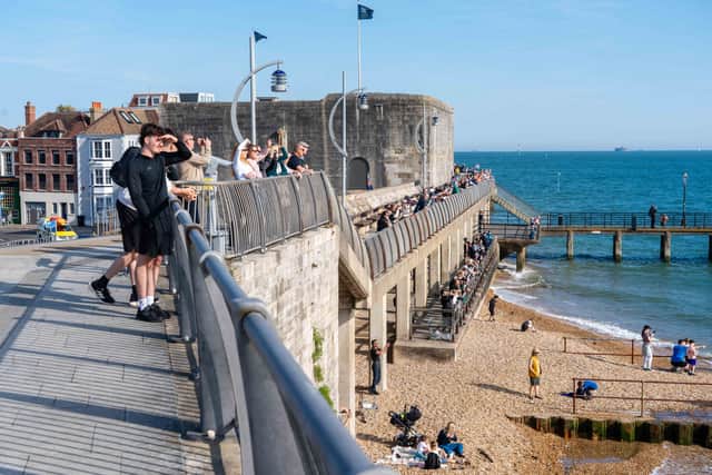 People gathered on the Hotwalls to see the Royal Navy aircraft carrier HMS Queen Elizabeth