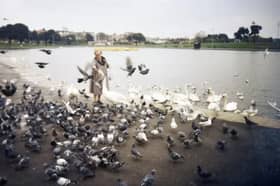 A woman feeding the birds at Canoe Lake in 1995 