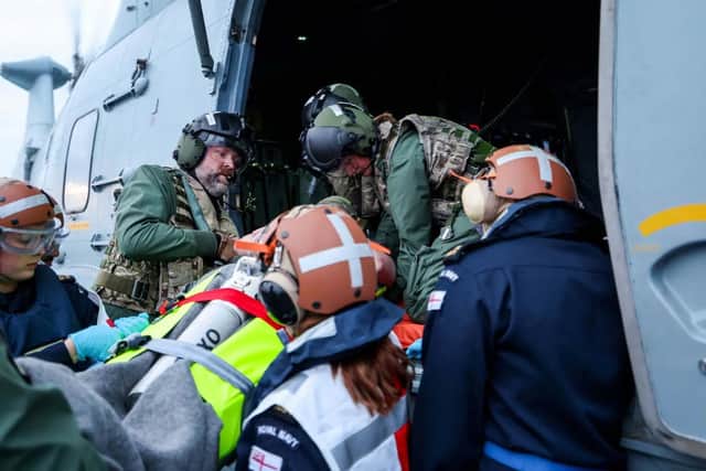 HMS Prince of Wales medical training exercise where personnel boarded HMS Duncan and transferred a 'badly-injured sailor' onto a helicopter.