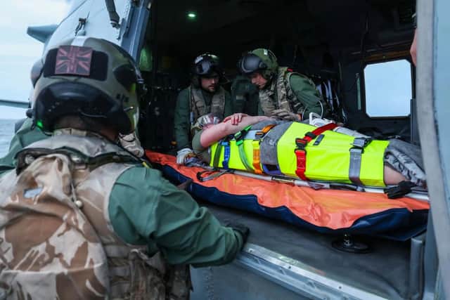 A sailor being placed onto a helicopter during a medical emergency exercise. HMS Prince of Wales medics are currently training in the Norwegian Sea.