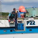Blue Marine team putting the oysters into their new home in the harbour.