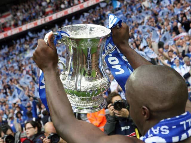 Former Pompey favourite Lassana Diarra lifts the FA Cup for Pompey in 2008 at Wembley. Picture: Joe Pepler