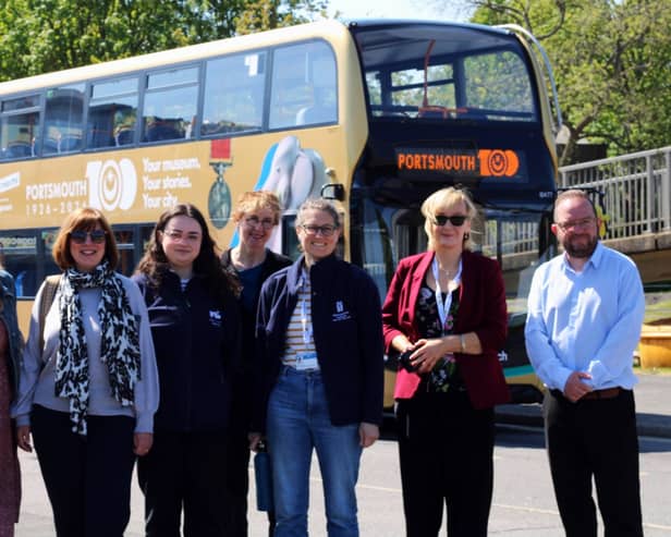 Portsmouth Museums staff in front of a bus promoting the Portsmouth100 Your museum. Your stories. Your city exhibition launching in October