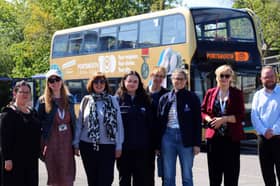 Portsmouth Museums staff in front of a bus promoting the Portsmouth100 Your museum. Your stories. Your city exhibition launching in October