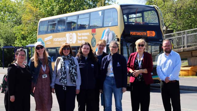 Portsmouth Museums staff in front of a bus promoting the Portsmouth100 Your museum. Your stories. Your city exhibition launching in October