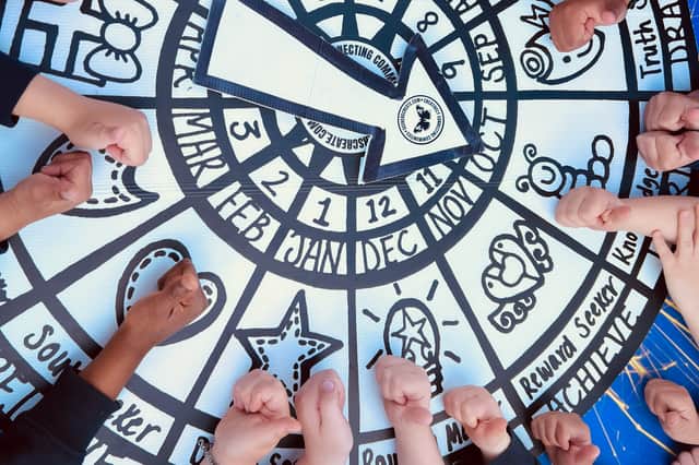 Children work on the playground mural at St George’s Beneficial Primary School in Portsea