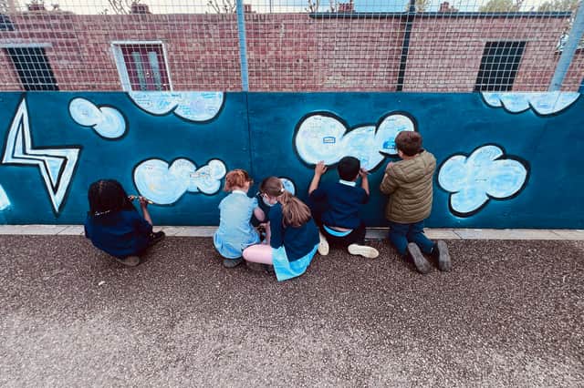 Children work on the playground mural at St George’s Beneficial Primary School in Portsea
