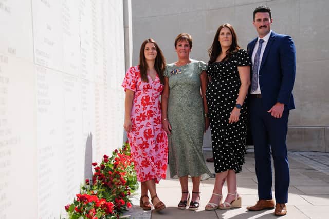 Georgina Chapman, Liz Chapman, Chloe Chapman and Ben Chapman observe a memorial wall including their father and husband Lieutenant Commander Darren Chapman, ahead of a Service of Remembrance at the National Memorial Arboretum in Alrewas, Staffordshire, to mark 15 years since the Iraq War.