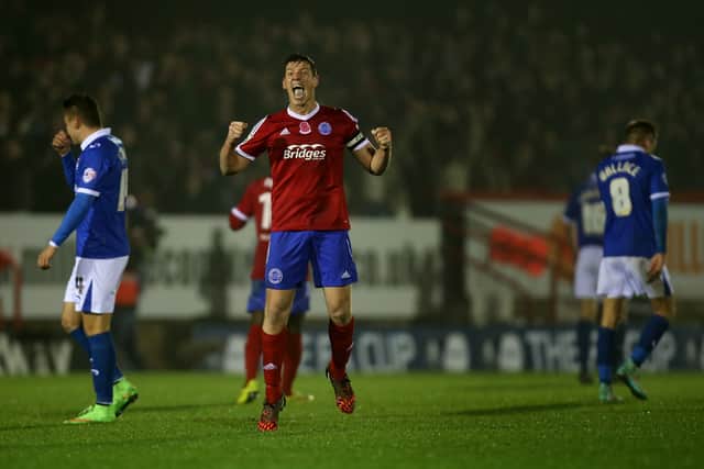 Aldershot captain Glenn Wilson celebrates at the final whistle during the FA Cup First Round Replay match between Aldershot Town and Portsmouth in 2014
