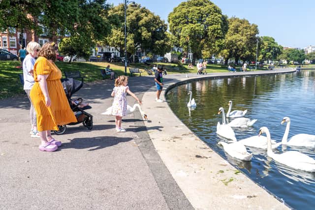People enjoying the bank holiday sun in Southsea at Canoe Lake.