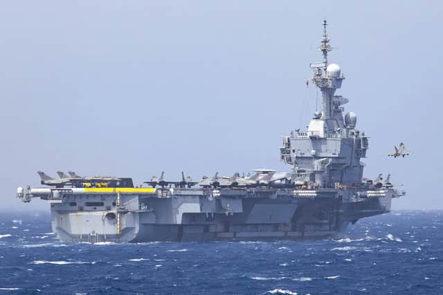 A Rafale jet pulls away from FS Charles de Gaulle after a catapult launch - as seen from HMS Dragon
