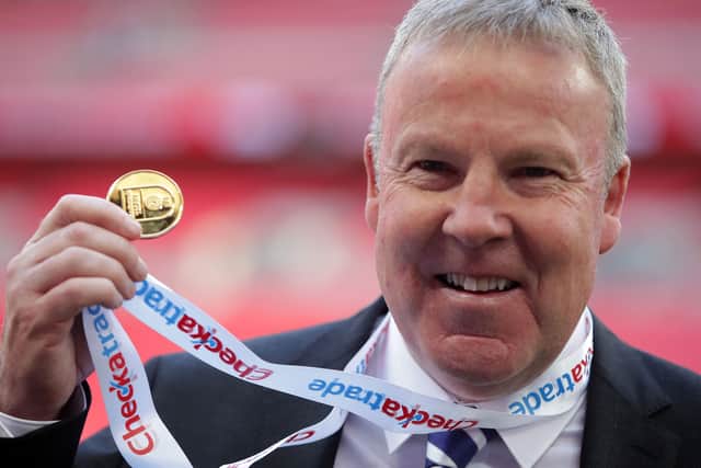 Kenny Jackett holds up his medal after winning the Checkatrade Trophy with Portsmouth