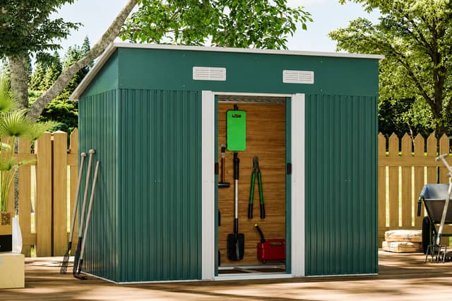 The galvanised steel shed includes lockable double doors, ventilation panels and an integrated floor