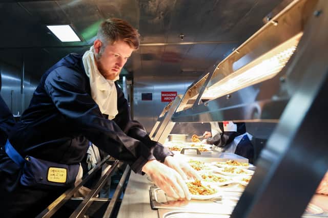 A member of ship's company in the galley during action messing. Ship's company of RFA Lyme Bay have been training with FOST at sea, they have been doing exercises on firefighting, damage control and causality evacuation, preparing them for future operations in the Gulf.