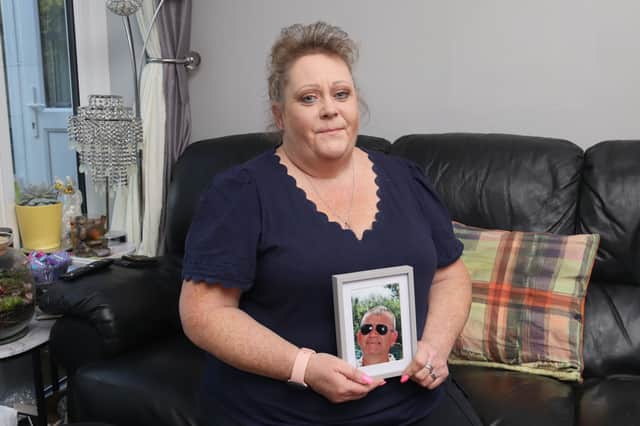 Pictured: Jo Parker at her home with a picture of her late husband, Graham, in Lovedean