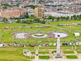 General public and military personnel gathered for a historic picture celebrating the 100th anniversary of Portsmouth as a city.