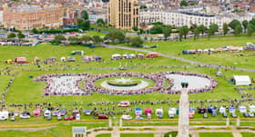 General public and military personnel gathered for a historic picture celebrating the 100th anniversary of Portsmouth as a city.