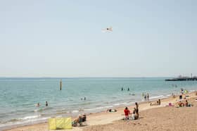 People enjoying the sunshine at Southsea seafront.