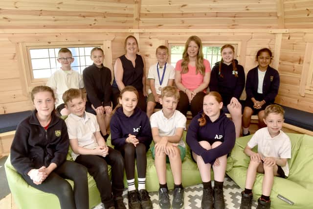 Clanfield Junior School in Little Hyden Lane, Clanfield, have received a positive result on their recent Ofsted report. 

Pictured is: (back third from left) Kate Pinhorne, deputy headteacher and (back third from right) Kati Dawkins, headteacher, with just some of the children in their nature cabin.

Picture: Sarah Standing (160626-3226)