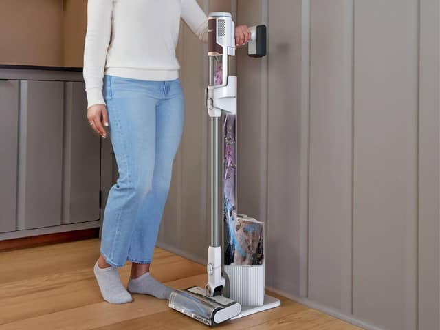 Shark’s Clean & Empty cordless vacuum returns to its charging dock after use, where collected dirt is transferred into a larger sealed base
