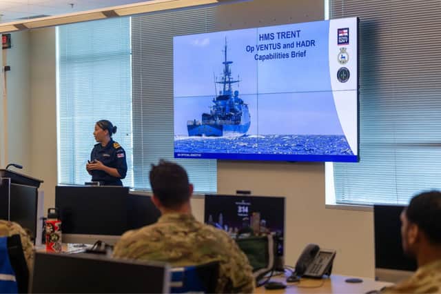 Lt Cdr Jenkins-Hill briefs Tampa's Emergency Operations Centre personnel on the ships disaster relief